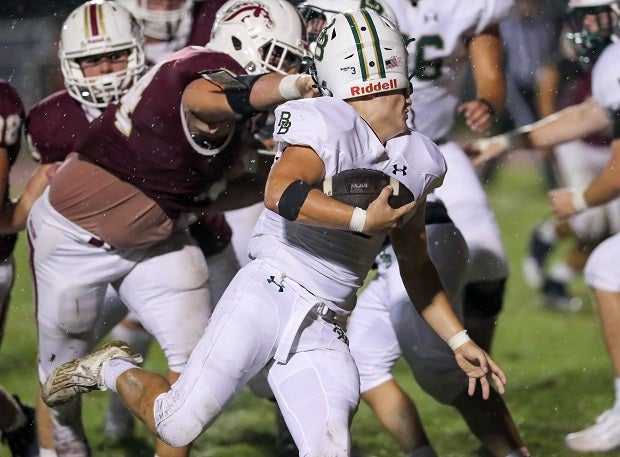 A River Bluff player gets his helmet twisted by a South Aiken player.