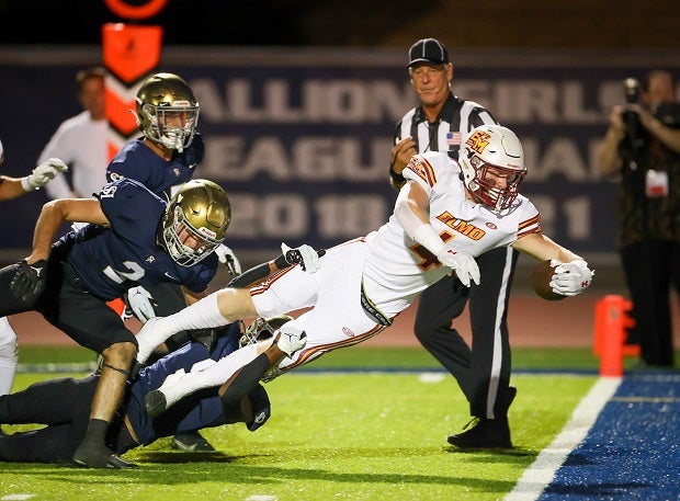 El Modena's Tayson Hitchens stretches for a touchdown.