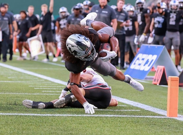 Arlington Martin running back Michael Barrow is upended as he stretches for a touchdown against Lake Travis at Choctaw Stadium in Arlington, Texas.