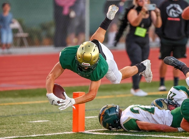 Casa Grande senior running back Ryder Jacobson dives for the pylon and touchdown against Maria Carrillo. 