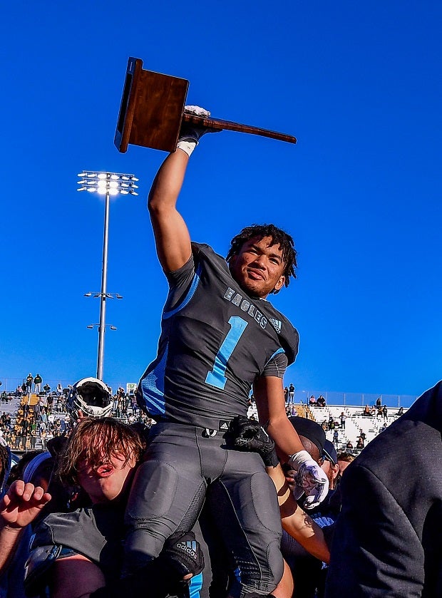Granite Hills sophomore running back Isaiah Jackson holds up the trophy after the CIF Division 2-A finals Saturday at Saddleback College in Mission Viejo. (Photo: Louis Lopez)