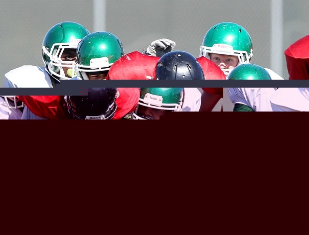 A host of El Cerrito (Calif.) players gang up to tackle a Salesian (Richmond, Calif.) ballcarrier.