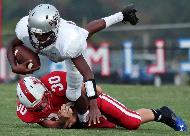 An Alcoa (Tenn.) ballcarrier just can't quite get past a Heritage (Maryville, Tenn.) player in a freshman game.