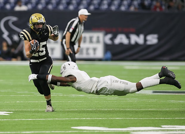 Manvel (Texas) linebacker Brian Johnson dives while attempting to tackle Nederland running back Nick Kingston in a UIL 5A Division I quarterfinal playoff game.