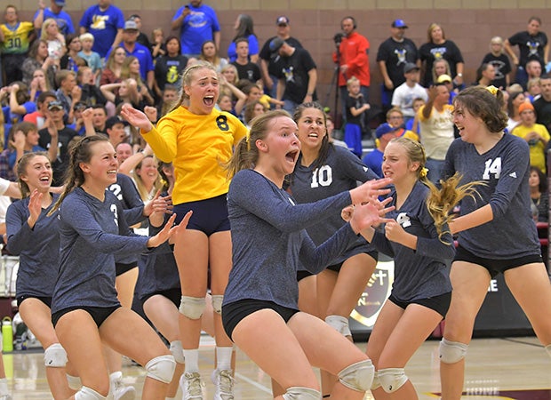 Boulder City (Nev.) players rush the court after winning the NIAA 3A state championship with a 3-2 victory over Moapa Valley.