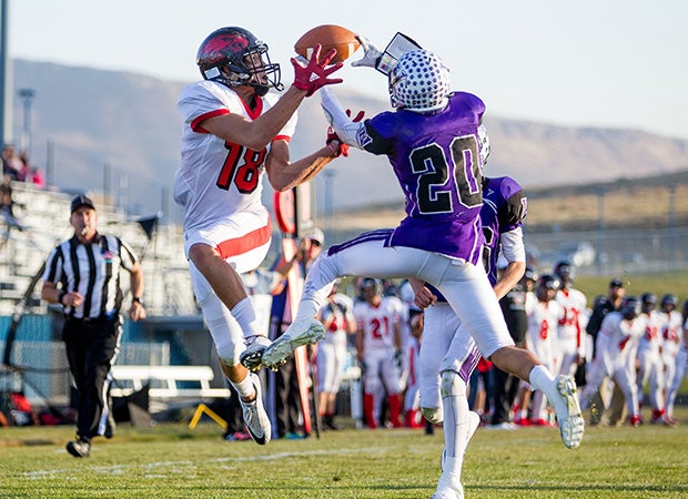 Arvada West (Colo.) defensive back Isaiah Ocana (right) breaks up a potential touchdown pass to Eaglecrest receiver Theryne Sandoval-Jimenez.