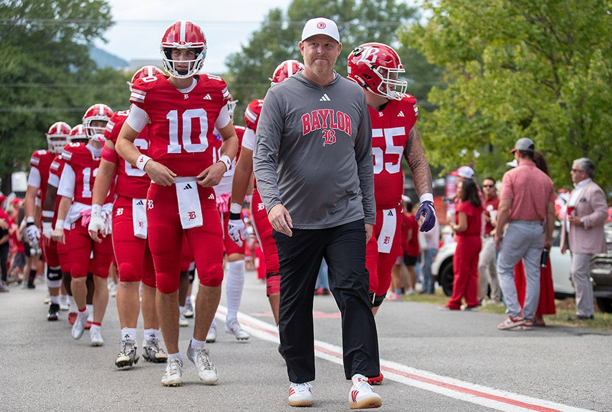 Baylor head coach Eric Kimrey takes the walk to lead his team into Friday night's battle with rival McCallie in Tennessee. Kimrey and the Red Raiders won big to extend their win streak to 19 games. (PHOTO: Andy Mitchell)