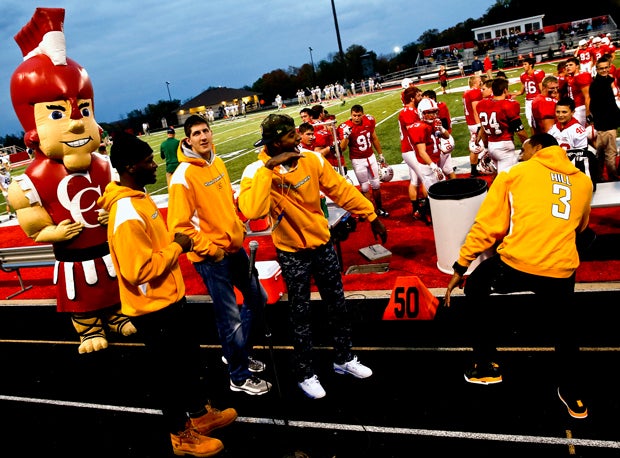 Pacers players Paul George and George Hill dance on the track before the start of the game while teammates Damjan Rudez and Adonis Thomas look on along with Center Grove's mascot.