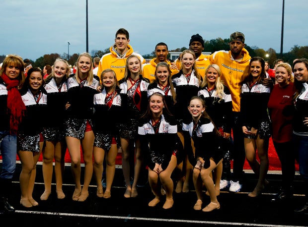 Indiana Pacers players Paul George, George Hill, Damjan Rudez and Adonis Thomas pose with the Center Grove varsity dance team before the start of the game on Friday.