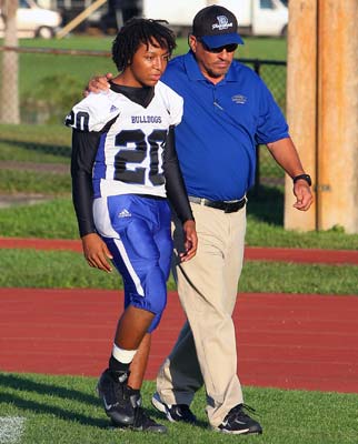 Braddock head coach Frank Rojas walks with Pollard
before Saturday night's game against Varela in Florida.