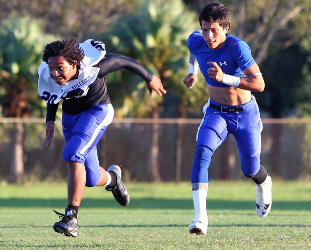 Pollard warms up by running with teammate Jamie Jarquin before last Saturday night's game.