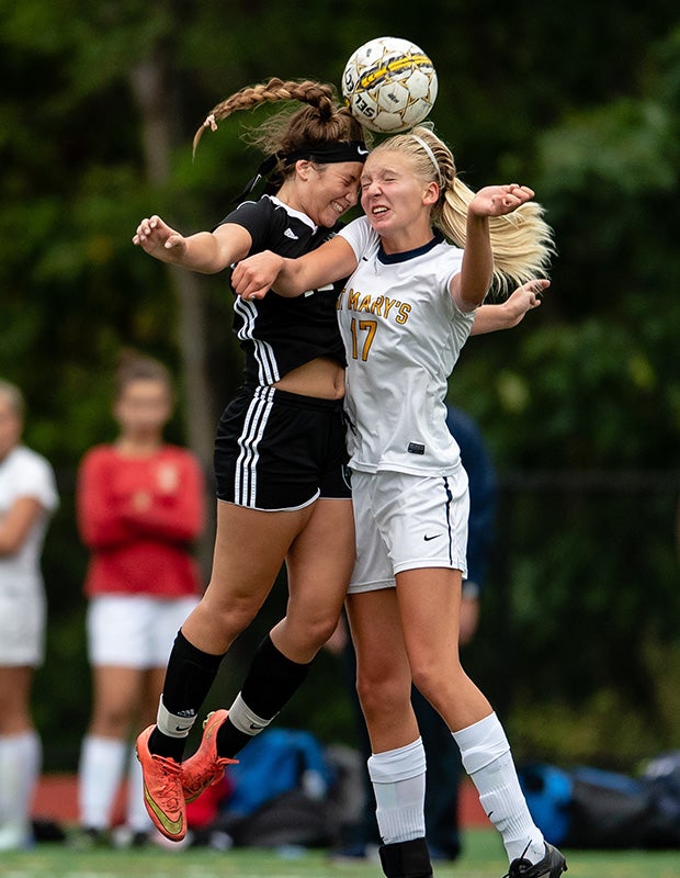 Austin Prep's (Mass.) Maddie Rinklin (left) challenges St. Mary's Susannah Cornell for a header.