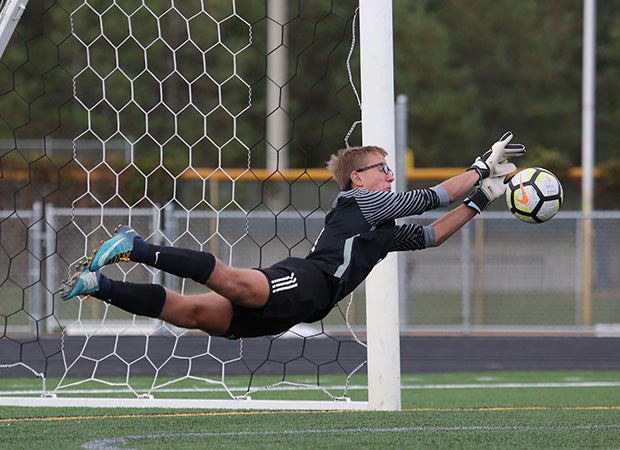 Jedidiah Bitter of Bemidji (Minn.) makes a diving save on a penalty kick by a Brainerd player.