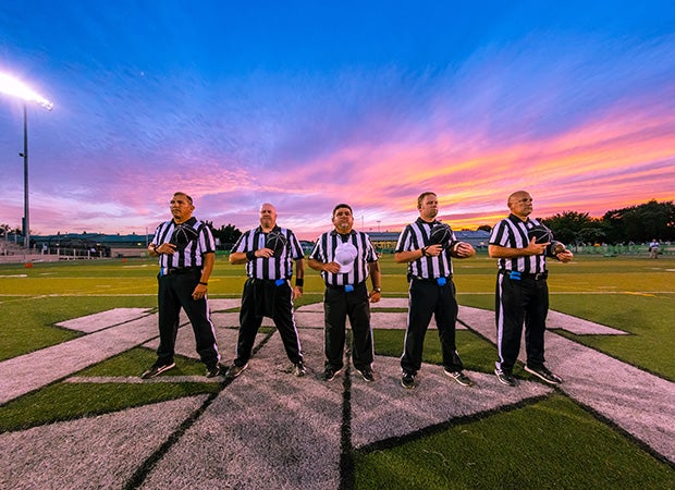 The officials stand at midfield during the National Anthem before the kick off of the Damonte Ranch at St. Mary's varsity football game in Stockton (Calif.).