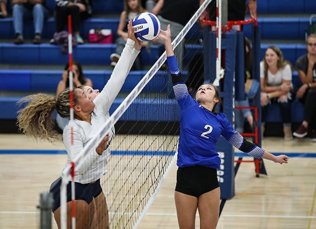 Emma Quarles (left) of Legacy (Colo.) tips it past the outstretched fingertips of Broomfield's Kristina Consbruck.