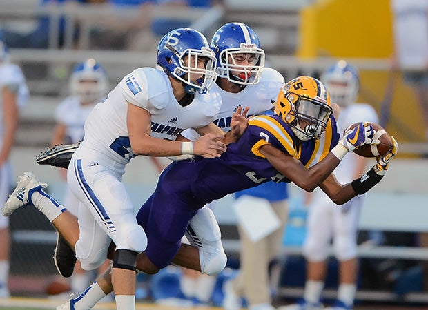 Thibodaux (La.) receiver Darwin Davis Jr. makes a diving catch while being covered by two South Lafourche defenders.