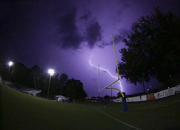 Lightning strikes in the background during a weather delay for the Columbia at Trinity Christian Academy (Fla.) varsity football game.