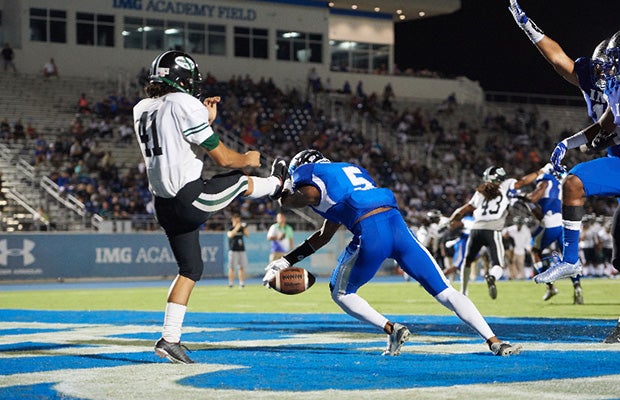 Ryker Brazerol of IMG blocks a Central punt attempt in the end zone.