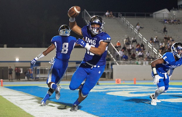 IMG's Xavier Thomas celebrates scoring a touchdown following a blocked punt.