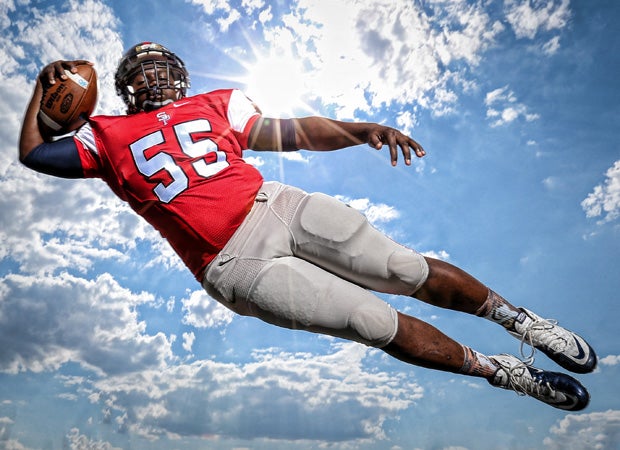 Offensive lineman Rodney Shaw soars through the air during a photo shoot at South Panola High School in May.