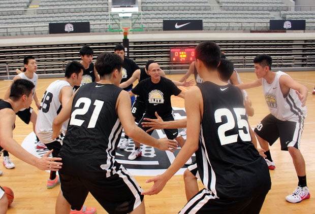 Coach Frank Allocco gives his signature defensive stance drill at the end of his first practice at the Nike High School Elite Camp in Shanghai, China. 