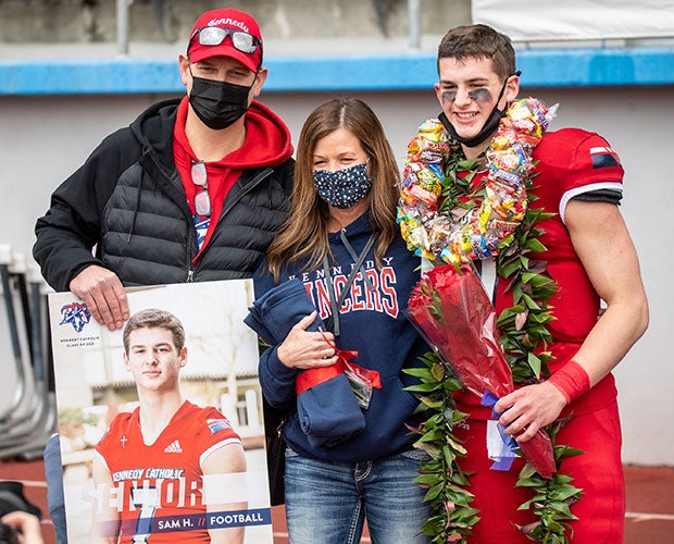 On Senior Day, Sam poses with his father, Damon, and mother, Julie.