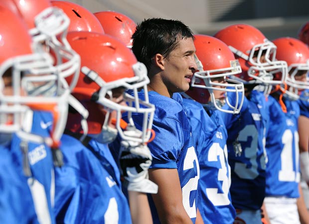 Biaggio Ali Walsh (without helmet) looks on from the sideline during a recent home game.