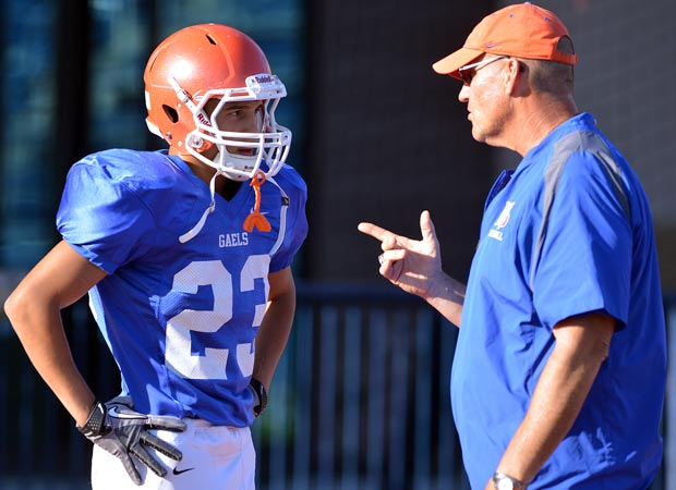 Biaggio Ali Walsh receives instruction from freshman coach Rob Burgman before a game. 