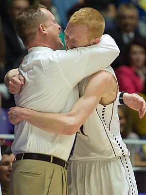 Coach Quincy Lewis and T.J. Haws embrace during
the state title game.