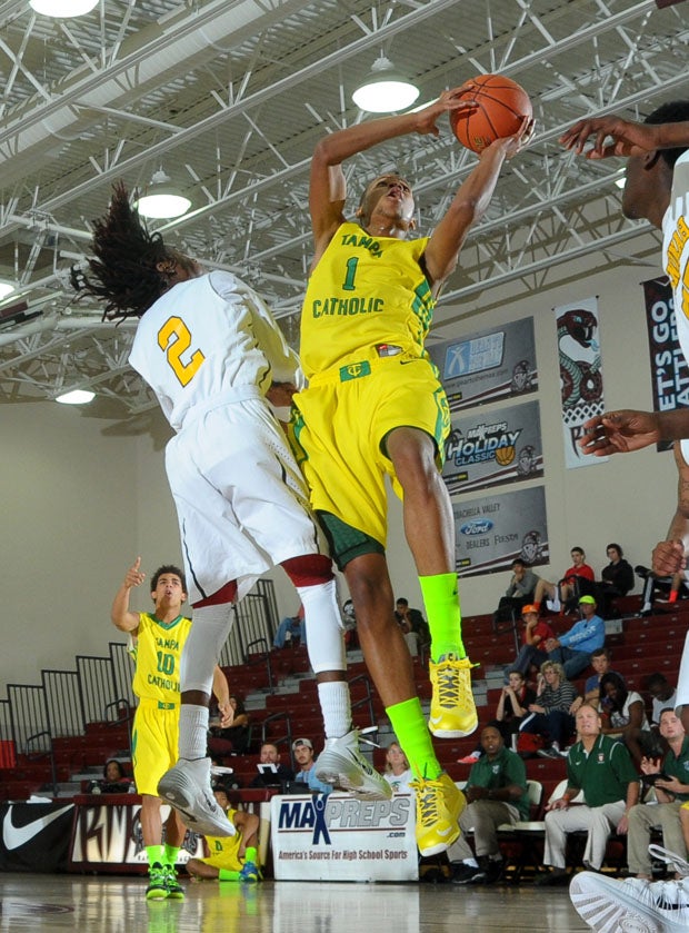 Tampa Catholic's Chivarsky Corbett (1) goes up for two of his 27 points against Wenonah's Cedric McGinnis.