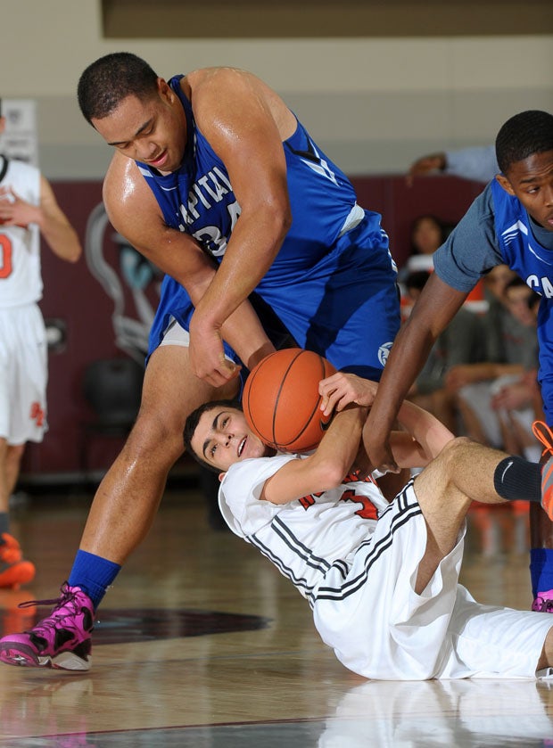 Stanford-bound football player Nifae Lealao, of Capital Christian, wrestles for the ball during a 62-49 second-round Invitational win over Beverly Hills Friday at Rancho Mirage High School.