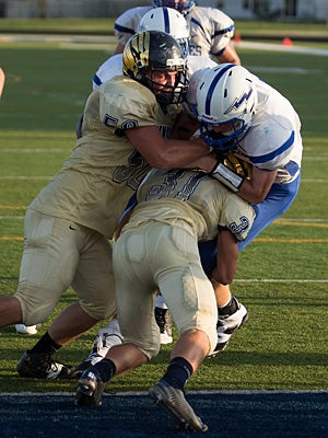 John Sidwell (50) and Austin Nelms (31) lead
the Decatur Central defense on this play. 