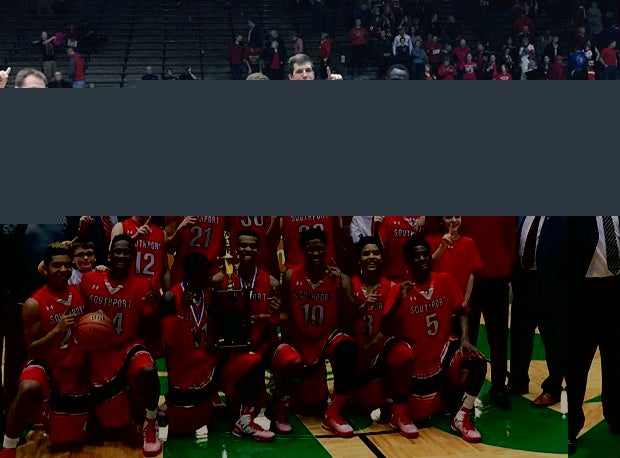 The Southport High boys basketball team celebrates after a tournament victory.