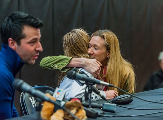 With coach David Glynn speaking at the microphone, Kerri Walsh-Jennings gives Polina Edmunds one last hug and good-luck wish before the 15-year-old leaves for Sochi.