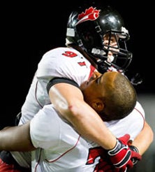 Canada players embrace following their
start-to-finish 23-17 win Saturday.