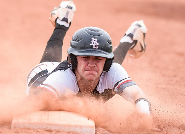 A Boulder Creek (Ariz.) player slides head first back into first base during a game against Juneau-Douglas (Alaska) in the Coach Bob Invitational in Arizona. 