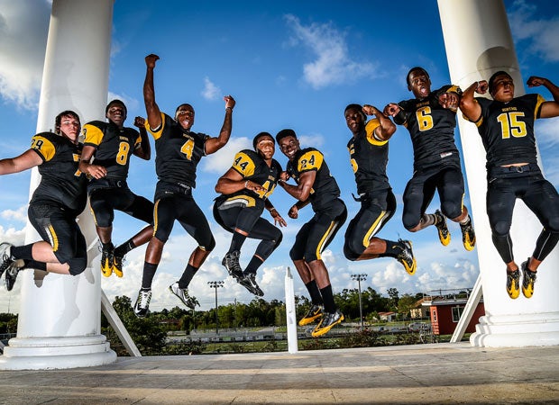 Jumping for joy are American Heritage players (left to right): Noah Bringas, Brandon Johnson, Dredrick Snelson, Anthony Flory, Tarvarus McFadden, Deonta Fair, Torrance Gibson and Andre Jumper.