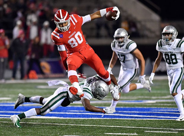 Mater Dei tight end Michael Martinez hurdles a defender just as the Monarchs eventually hurdled over the Spartans for a second straight season.