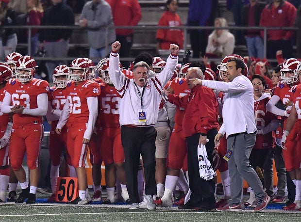 Mater Dei coach Bruce Rollinson raises his arms triumphantly as the Monarchs clinched their second straight CIF Open Division title and his 300th career win.