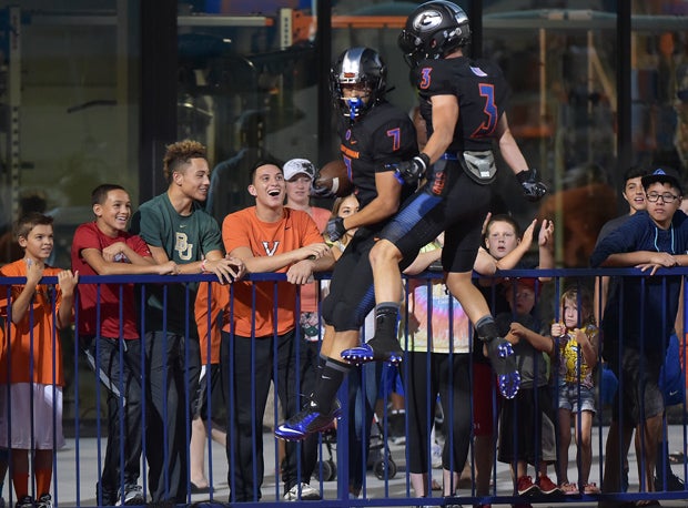 Biaggio Walsh (7) celebrates with Brandon Gahagan (3) after Walsh's early touchdown.