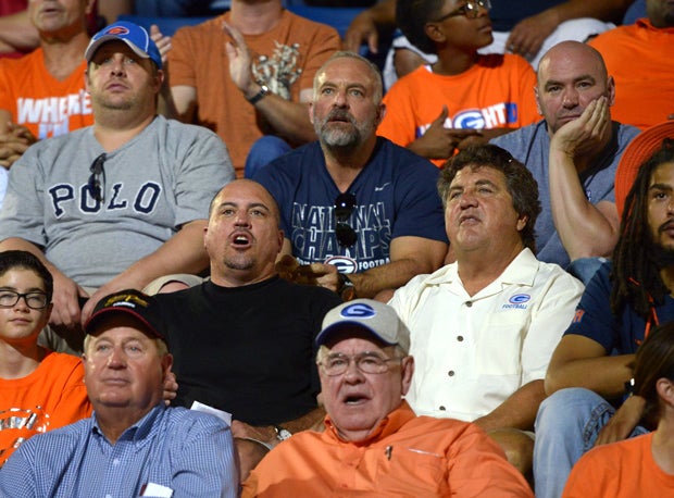 Former Bishop Gorman coach (current UNLV head coach) Tony Sanchez, in the black shirt, watches while Ultimate Fighting Championship executives Lorenzo Fertitta (left) and Dana White (right) sit in the next row behind.