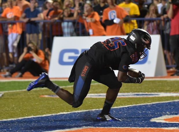 Bishop Gorman's Tyjon Lindsey tumbles into the end zone after a touchdown catch.