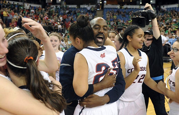 Modesto Christian coach Robb Spencer hugs Viviana Vasquez after his team's 64-55 win in the Division III state title game over Santa Barbara at Sleep Train Arena.