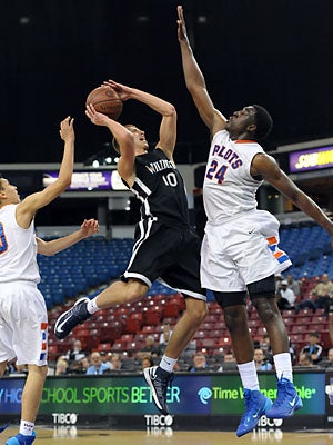 St. Joseph's Temidayo Yussuf (24) defends Alex
Gaizauskas (10).