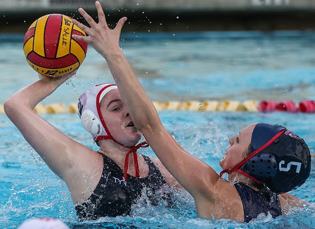 A Mayfield (Calif.) player looks to pass the ball while defended by a La Salle player.