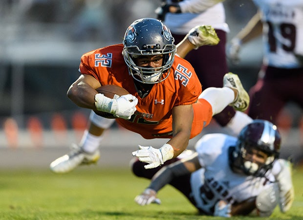 Skyridge (Utah) running back Ma'a Notoa soars for extra yardage during the Falcons' UHSAA 5A quarterfinal game against Jordan.