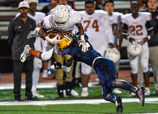 Lamar (Texas) cornerback Deshawn Gaddie launches Bowie receiver Jordon Joyner. 