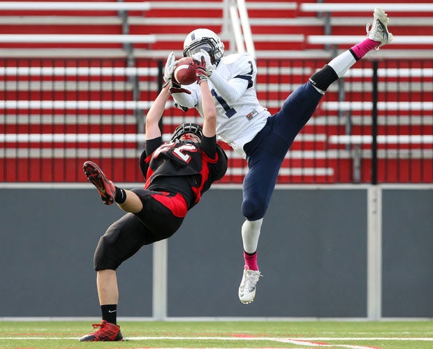 Gates Chili receiver Isaiah Brown (top) battles a Penfield defensive back for possession of the ball during a New York game in November.