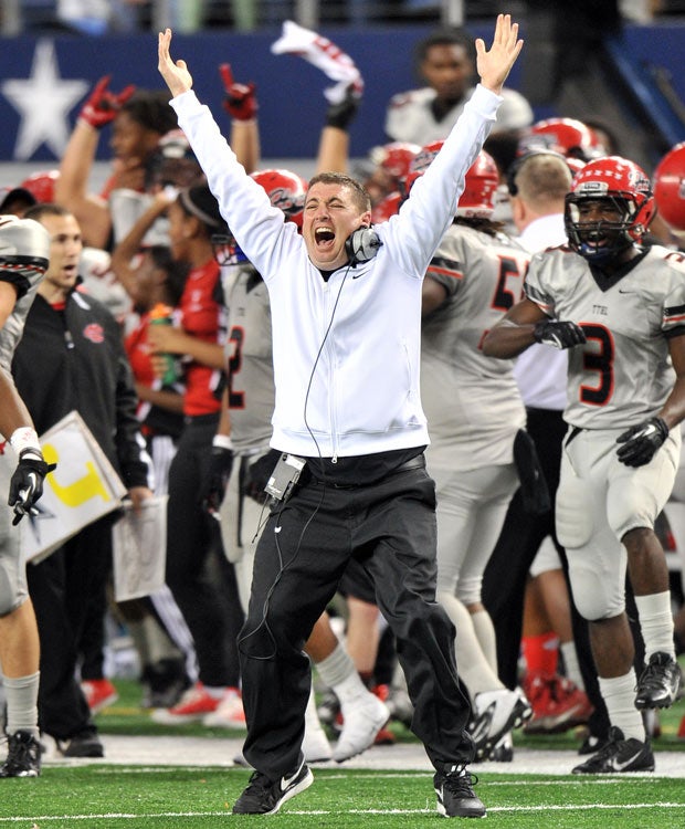 Cedar Hill running backs coach Kyle Morales celebrates a Longhorns touchdown in the final minutes of a victory over Katy in Texas' UIL 5A Division 2 state championship game at AT&T Stadium in December.