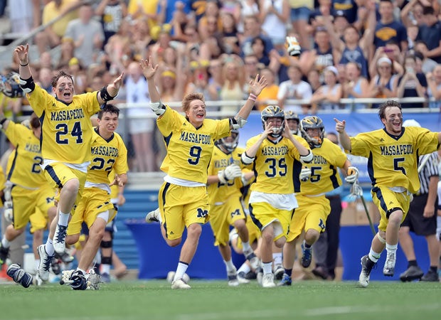 Massapequa lacrosse players rush the field while celebrating their victory over Fayetteville-Manlius in New York's NYSPHSAA Class A state championship game in April.